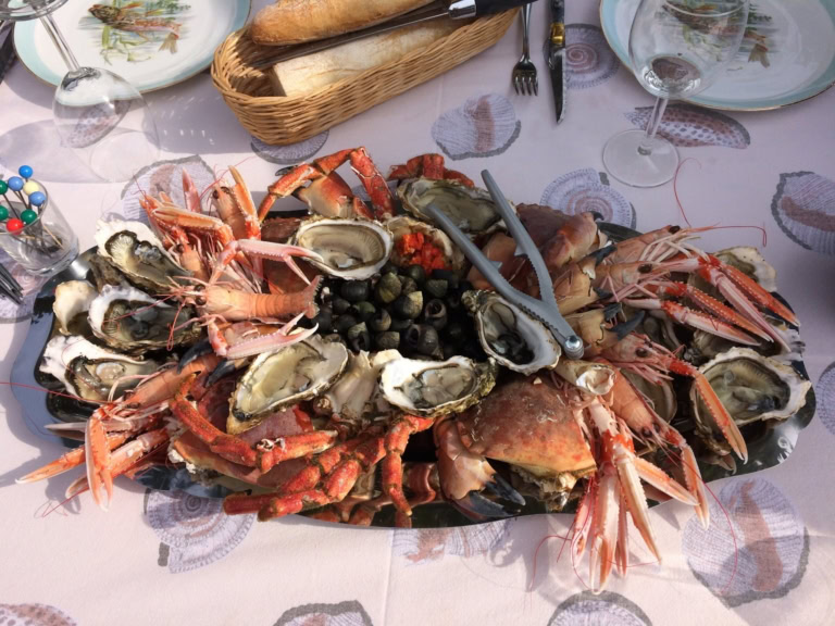 Seafood platter with oysters, crabs, shrimp, and mussels, perfect for a communal dining experience.