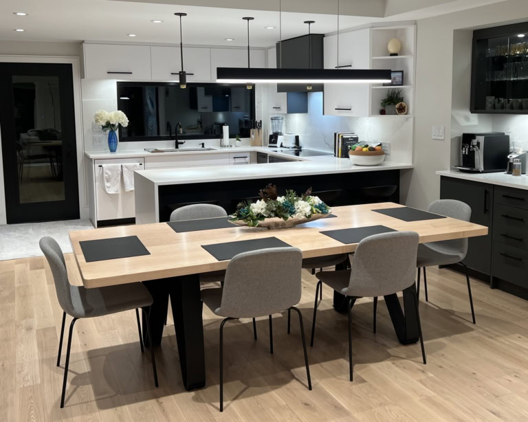 Modern kitchen and dining space with minimalist design, wood accents, and natural lighting.