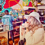 Bright, lively café interior featuring colorful wall art, casual ambiance, and guests savoring delicious treats.
