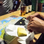 Delicious gourmet cheese with a map and drinks at The Gourmet Host.