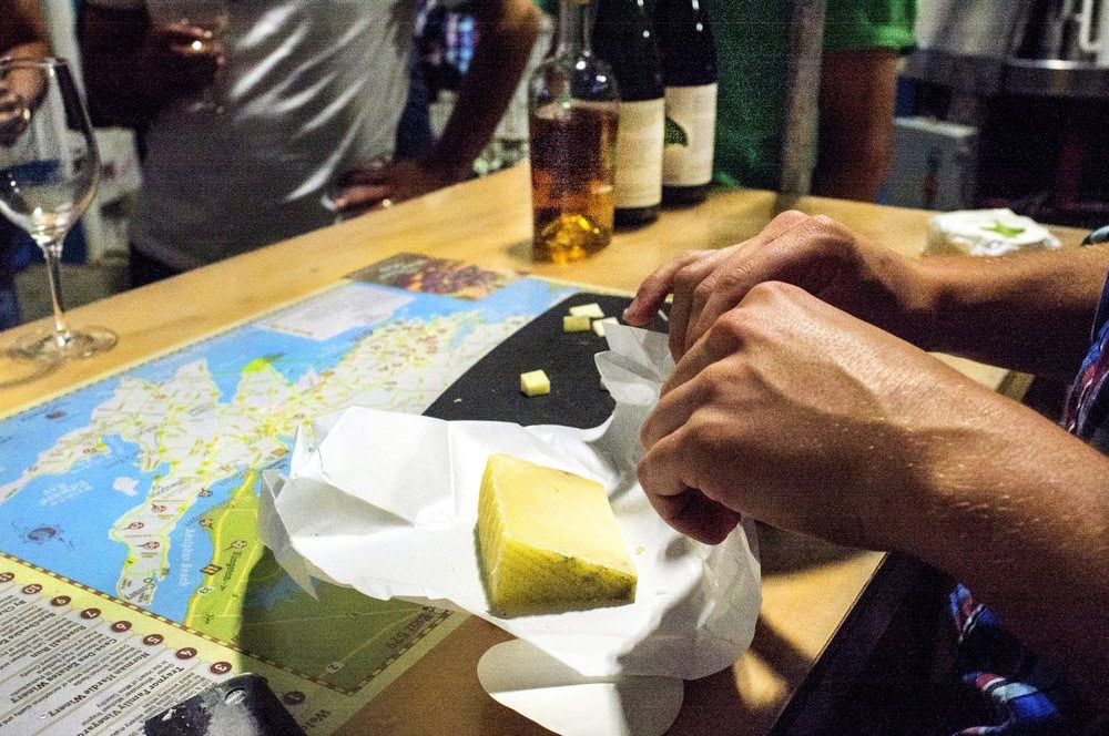Delicious gourmet cheese with a map and drinks at The Gourmet Host.