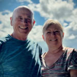 Happy elderly couple outdoors on a sunny day.