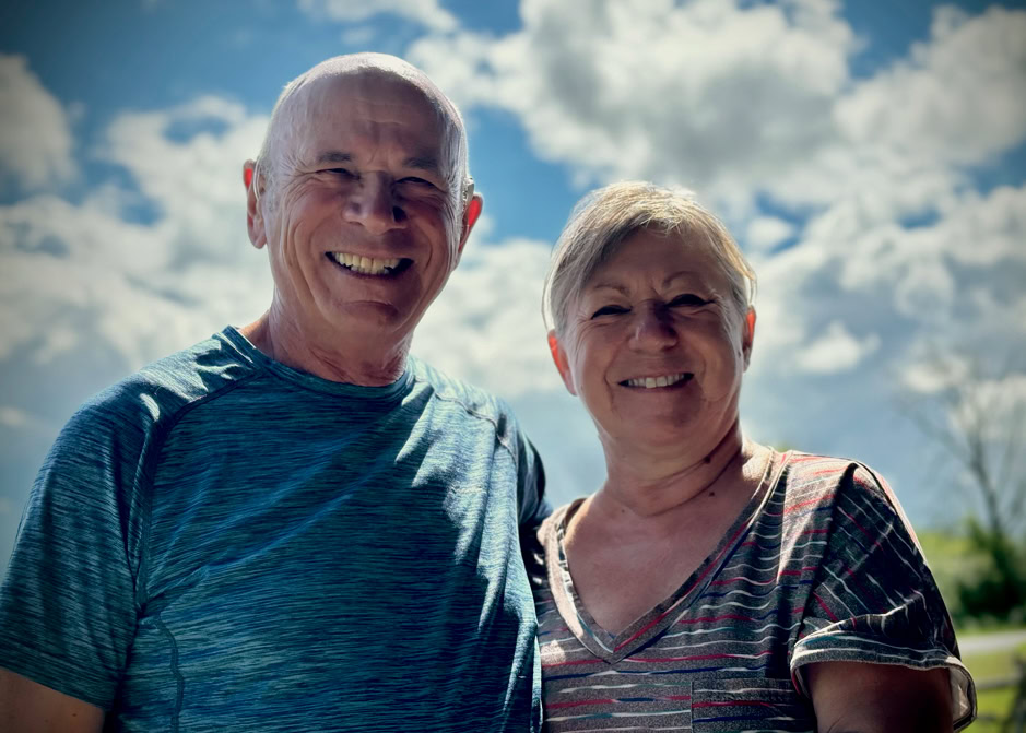 Happy elderly couple outdoors on a sunny day.
