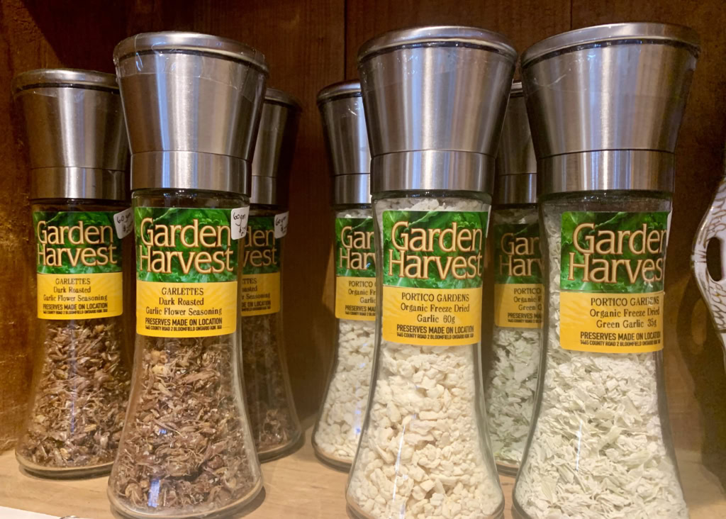 Fresh dried garlic and herbs in glass Spice jars, perfect for gourmet cooking and seasoning.