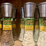 Fresh dried garlic and herbs in glass Spice jars, perfect for gourmet cooking and seasoning.