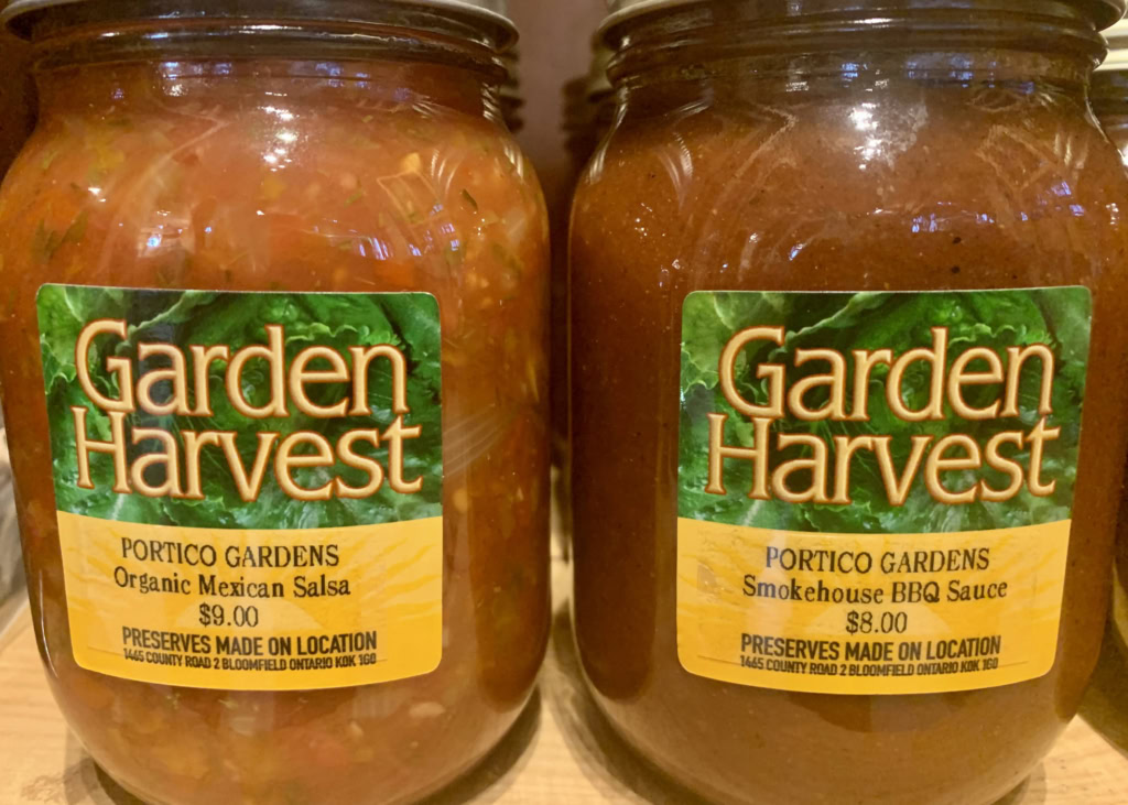 Close-up of jars of organic Mexican salsa and smoked barbecue sauce from Garden Harvest.