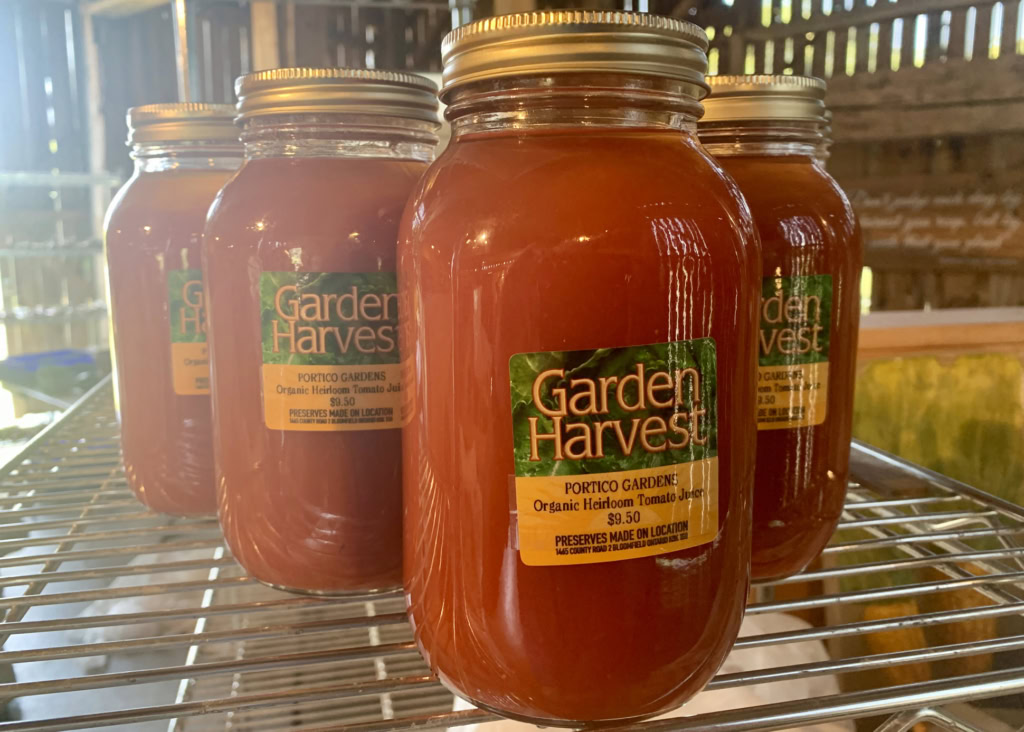 Fresh organic tomato juice in glass jars at Garden Harvest, ideal for healthy home cooking.