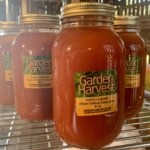 Fresh organic tomato juice in glass jars at Garden Harvest, ideal for healthy home cooking.