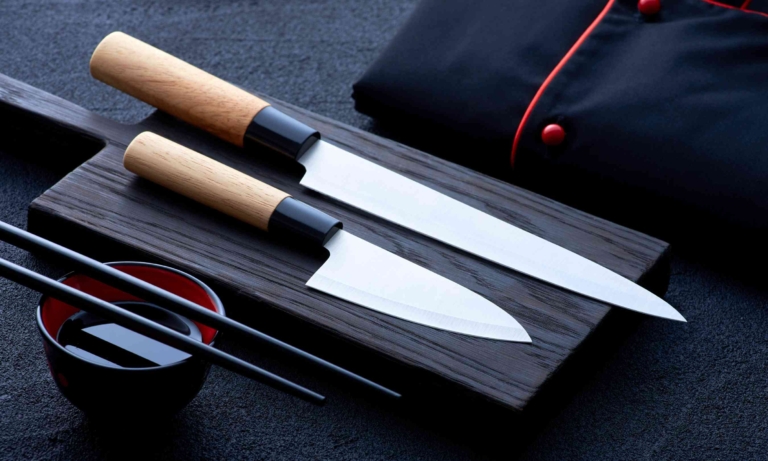 Japanese knives and chopsticks on dark cutting board showcasing culinary craftsmanship and Asian influences.