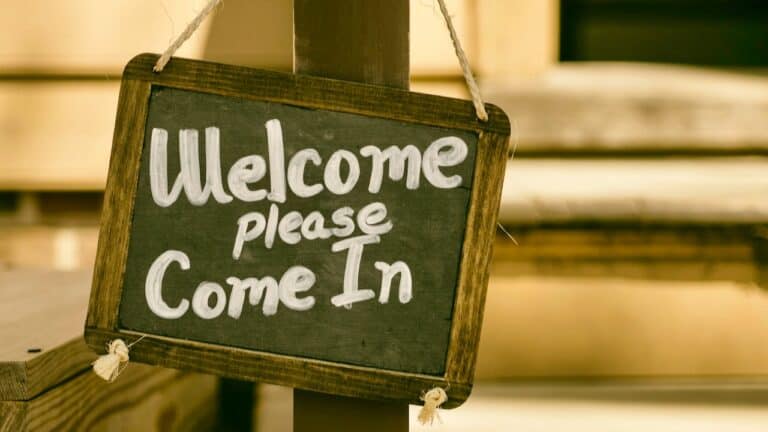 Welcome sign with "Welcome please Come In" in chalkboard style.