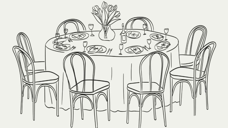 Elegant dining table with tulip centerpiece, set for seven guests, perfect for gatherings.