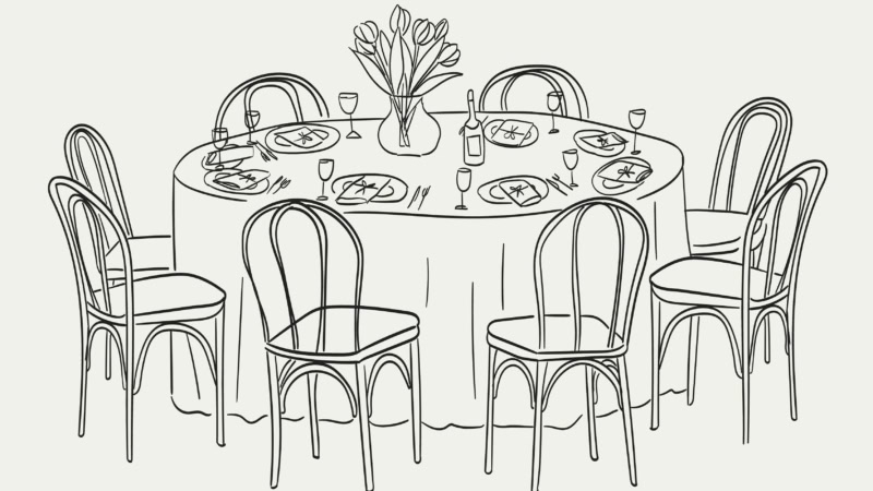 Elegant dining table with tulip centerpiece, set for seven guests, perfect for gatherings.