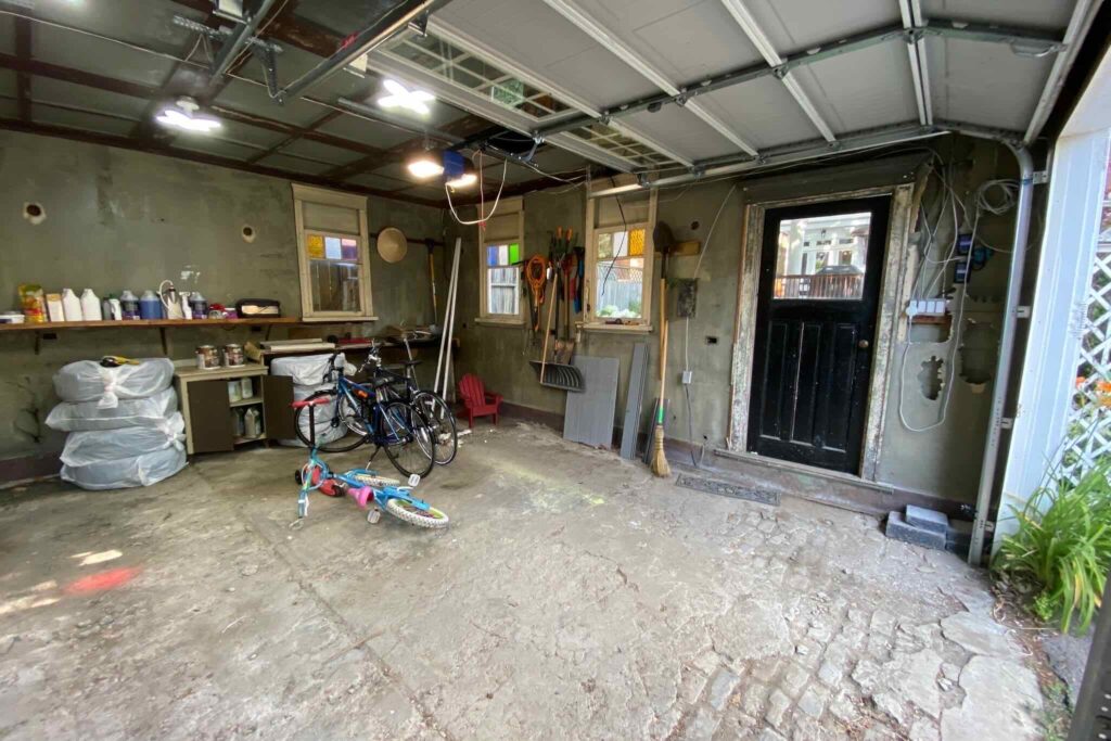 Organized garage with workbench, tools, bikes, natural light, family and DIY vibes.