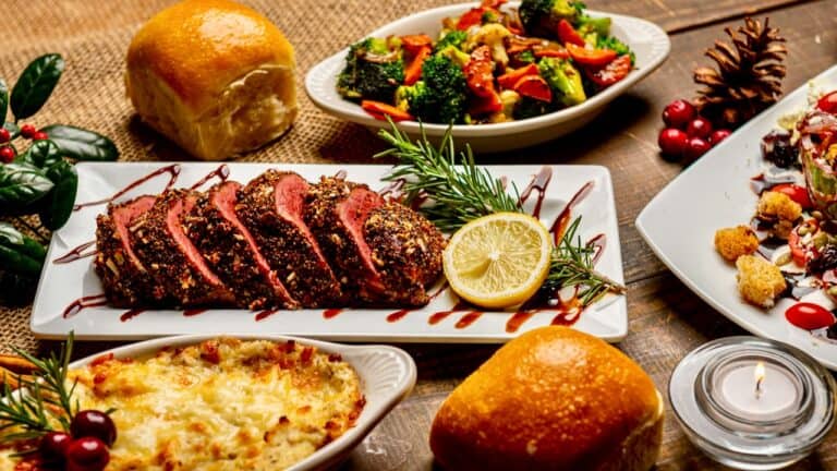 Elegant holiday dinner party with roasted meat, salads, bread, and desserts.