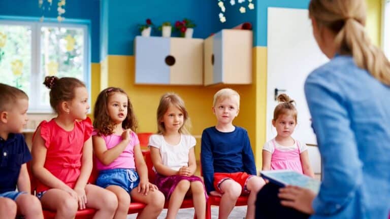 Engaging children in a classroom activity with a teacher leading a small group discussion.