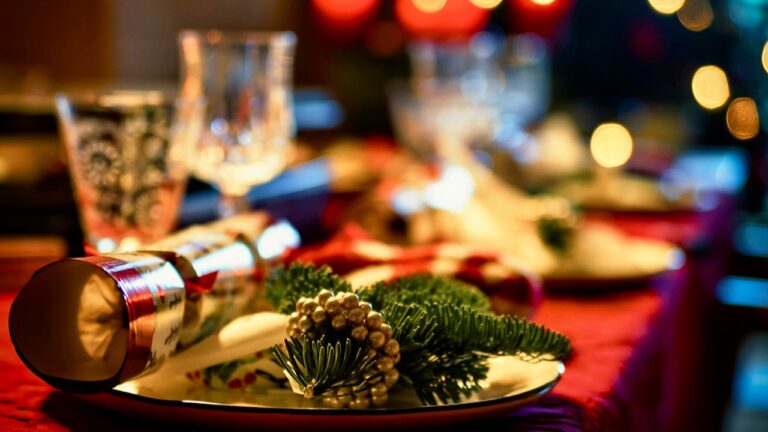 Elegant holiday dinner table with festive decorations and candles.