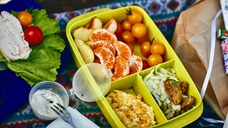 Colorful healthy lunchbox with fruit, vegetables, and snacks for kids.