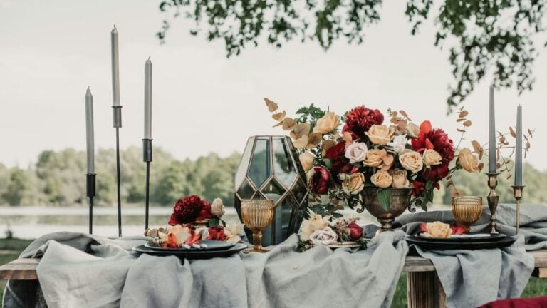 Elegant dinner table setup with floral arrangements, candles, and sophisticated tableware for specia.