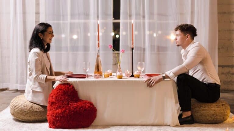 Romantic dinner setup with a couple at a cozy table for two.