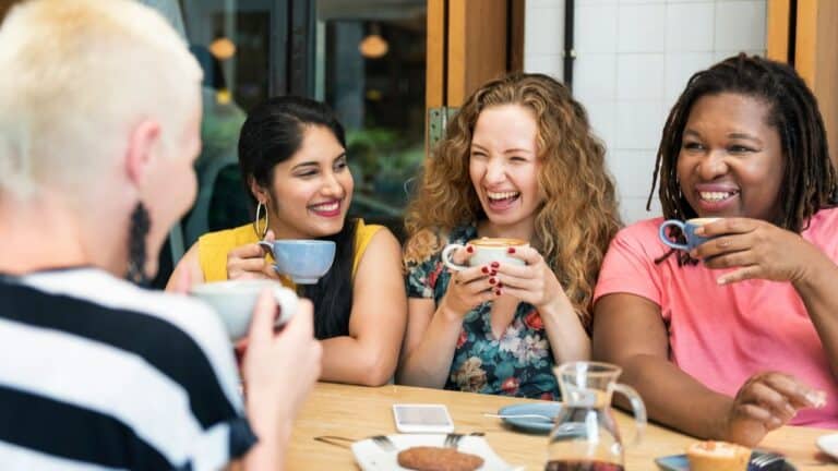 Group of diverse women enjoying conversation games at a social gathering.