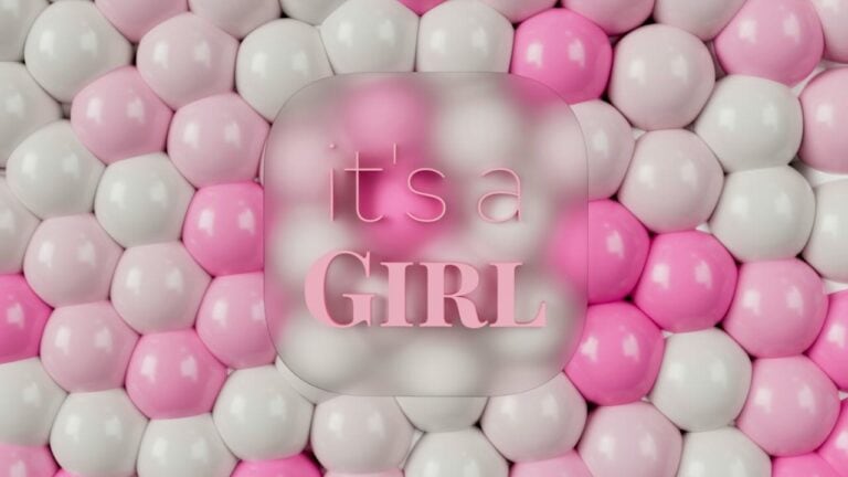 Pink and white balloon wall with "It's a Girl" message for baby shower.
