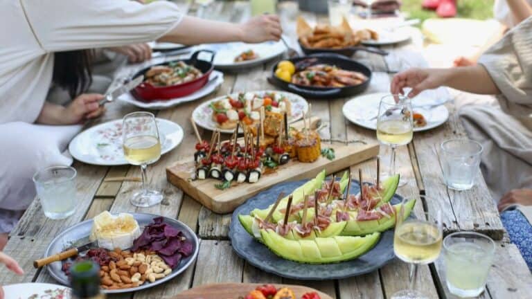 Delicious outdoor summer dinner party with fresh appetizers and drinks.