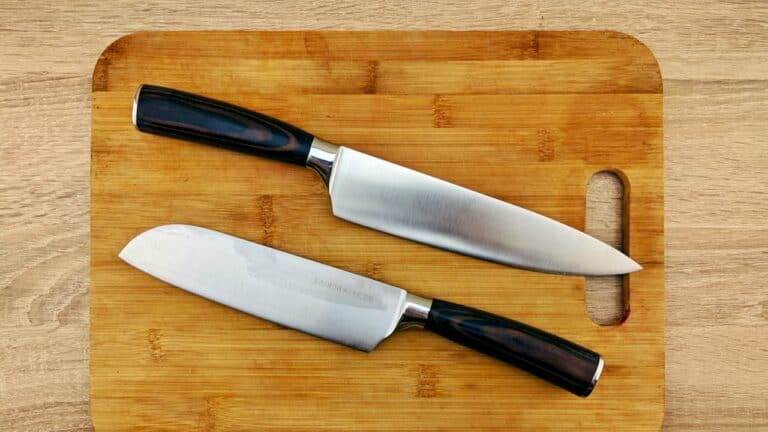 Chopping knives on a wooden cutting board for gourmet food preparation.