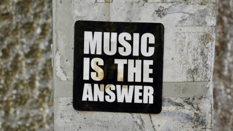MUSIC IS THE ANSWER sign on concrete wall for music lovers and motivational decor.