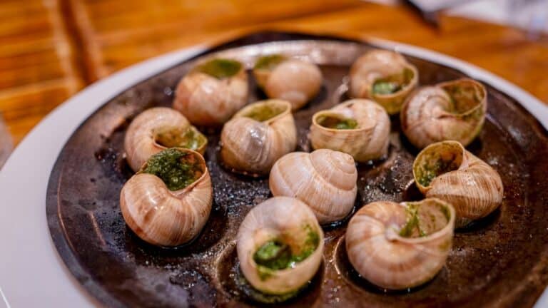 Succulent stuffed snails served on a rustic cast iron skillet for gourmet dining.