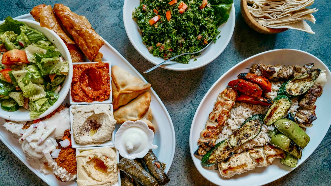 Fresh Mediterranean platter with grilled vegetables, salads, and assorted appetizers.