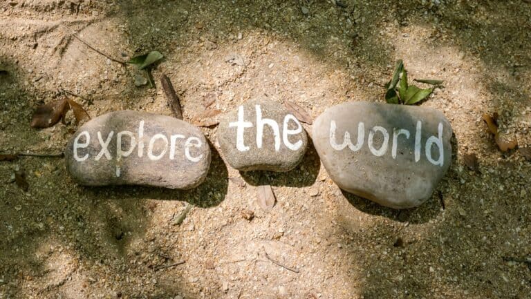 Explore the world written on stones in an outdoor setting, inspiring adventure and discovery.