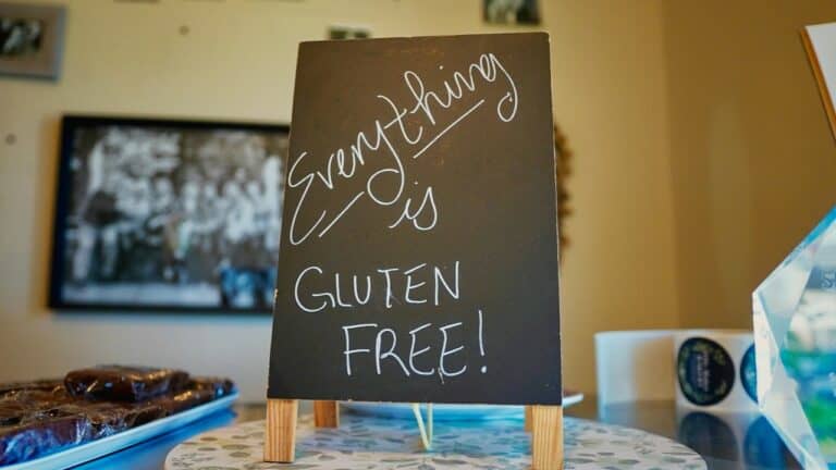 Gluten-free sign at The Gourmet Host promoting allergy-friendly dining options.