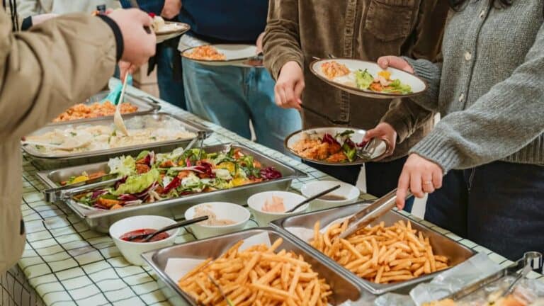 A delicious family buffet with pasta, salads, and side dishes for budget-friendly meals.