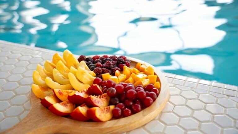 Colorful fresh fruit platter by the poolside for a summer pool party.
