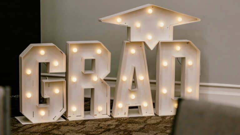 Large illuminated 'GRAD' sign for graduation celebration decor.