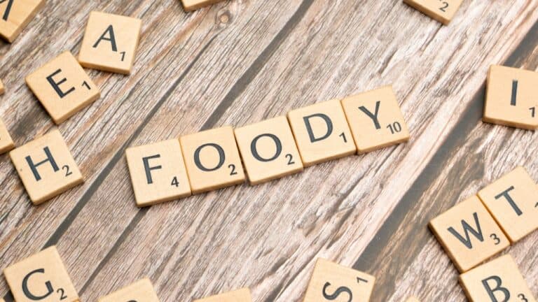Healthy food concept spelled with wooden letter tiles on a rustic wooden surface.