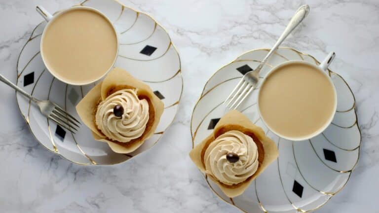Elegant coffee cups with desserts on stylish plates, perfect for gourmet breakfast or brunch.