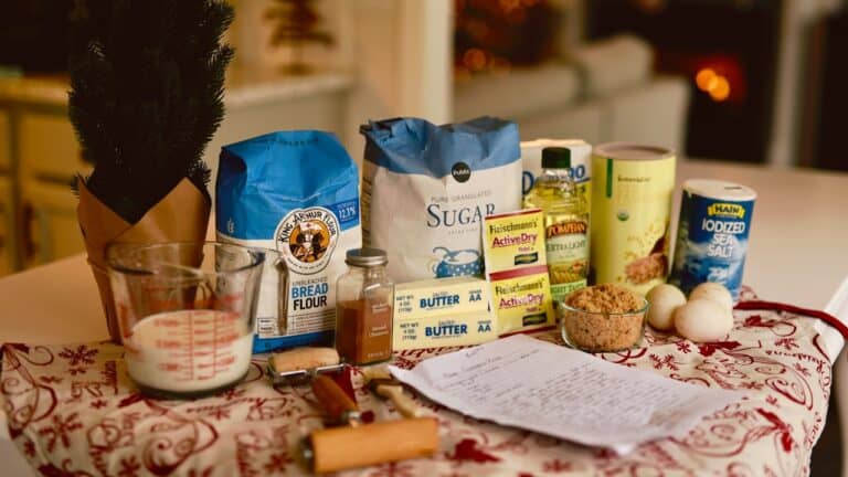 Fresh baking ingredients and utensils arranged on a festive table for holiday cooking.