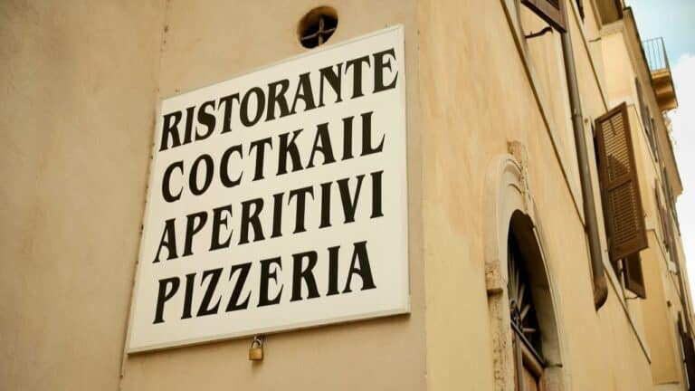 Authentic Italian restaurant sign with menu offerings including cocktails, aperitifs, pizzeria, and.