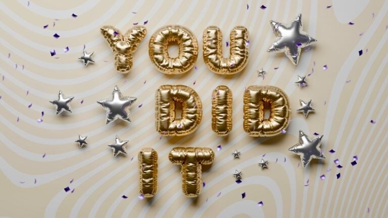 Gold and silver balloons spell 'YOU DID IT' for graduation celebration.