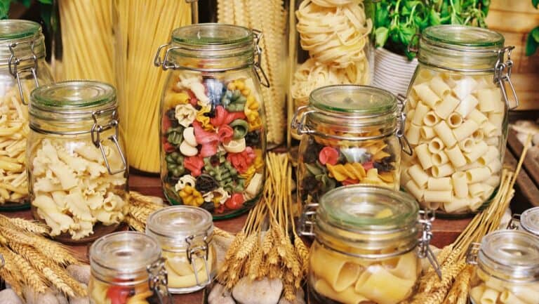 Fresh pasta and colorful pasta varieties in glass jars at The Gourmet Host.