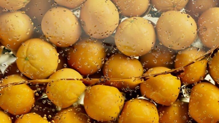 Fresh yellow gooseberries with water droplets, close-up shot.