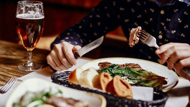 Gourmet steak dinner with vegetables and wine at The Gourmet Host restaurant.