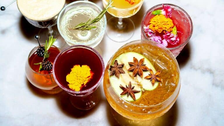 Assorted colorful non-alcoholic drinks in elegant glasses for a host's gathering.