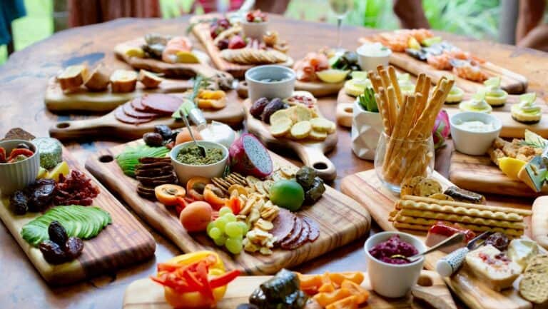 Assorted finger foods and desserts for a retirement party on wooden platters.