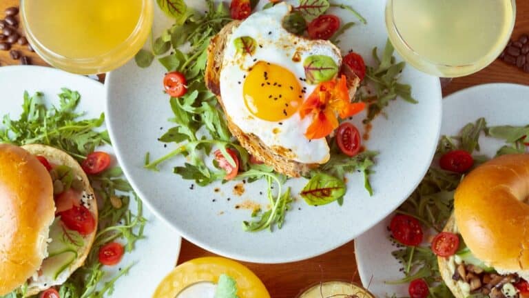 Delicious brunch spread with eggs, bagels, and fresh vegetables for a perfect weekend meal.