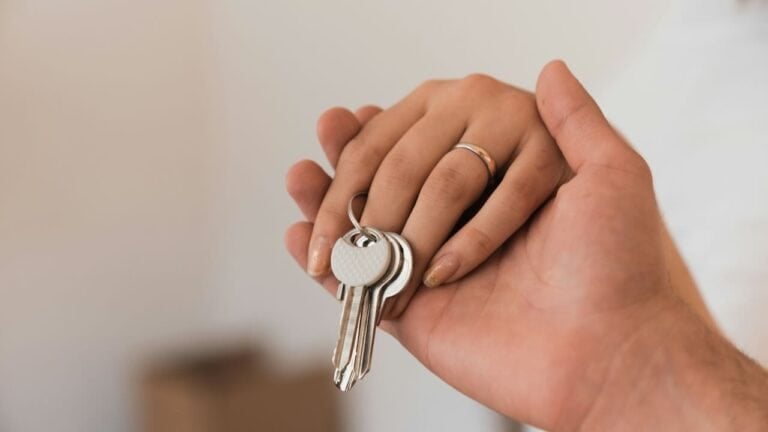 Person holding a set of keys for housewarming celebration.