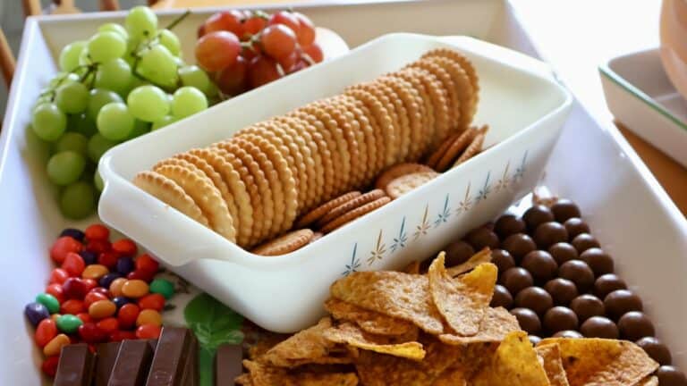 Assorted snacks including cookies, grapes, and chocolates for Super Bowl party.