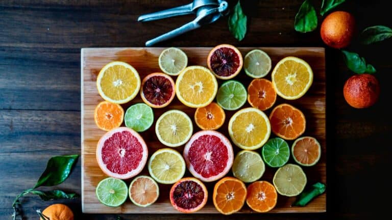 Colorful citrus slices arranged on a wooden board for cooking or garnish.
