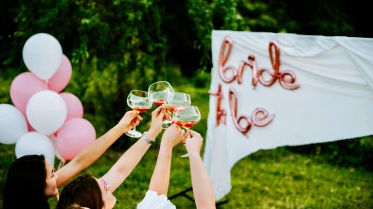 Guests toasting with wine glasses at a bridal shower celebration.